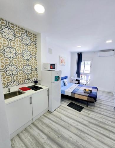 a room with a kitchen and a bed in it at Apartamentos Lindux Airport in Manises