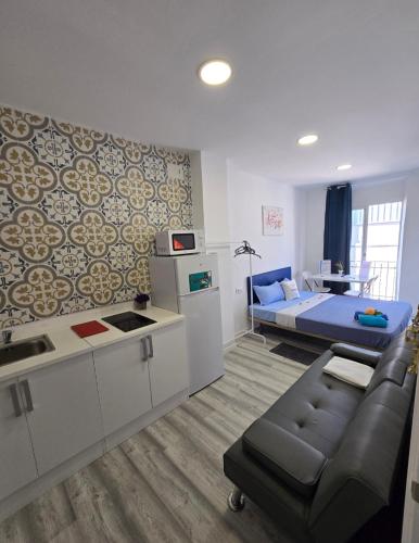 a living room with a couch and a bed at Apartamentos Lindux Airport in Manises