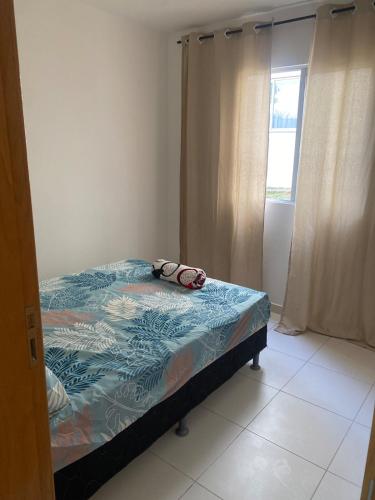 a bedroom with a bed with a towel on it at Apartment - Pedro Leopoldo in Pedro Leopoldo