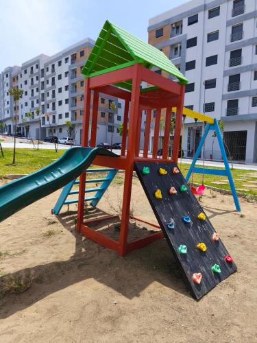 a playground with a slide in the sand at Cosy Flat with IPTV, BB gear Married couples only in Tangier