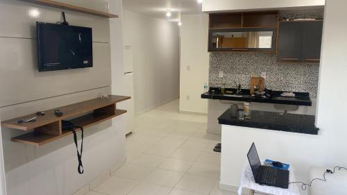 a kitchen with a tv on the wall at Apartment - Pedro Leopoldo in Pedro Leopoldo