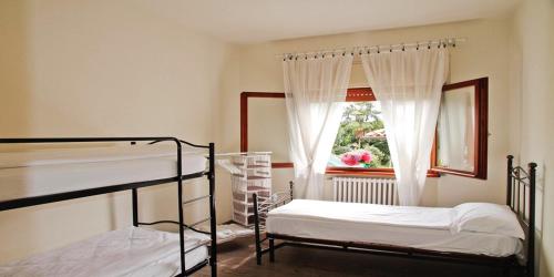 a bedroom with two bunk beds and a window at Isola Bella in Ossuccio