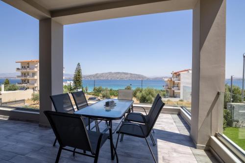 a patio with a table and chairs and a view of the ocean at marYsol luxury maison in Eantio