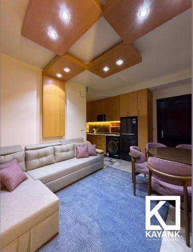 a living room with a couch and a table at Luxurious Family Chalet - Sia Lagoon, Porto Golf Marina, El Alamien - Lagoon View in El Alamein