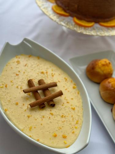 a bowl of soup with a cross on top of it at Hotel Florença in Talatona