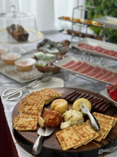 a table with a plate of food on a table at Hotel Florença in Talatona