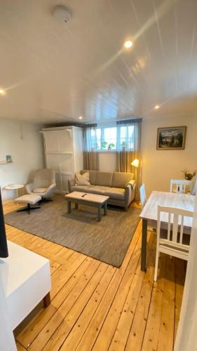 a living room with a couch and a table at Little red house located 400m from university in Örebro in Örebro
