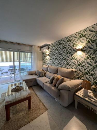 a living room with a couch and a wall mural at Casa Sant Antoni in Calonge