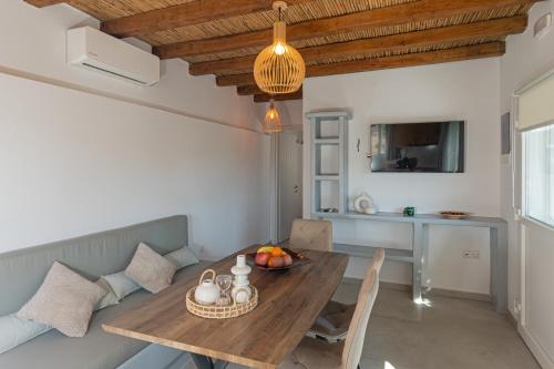 a kitchen and dining room with a wooden table and chairs at Casa Giardino in Livadi Astypalaias