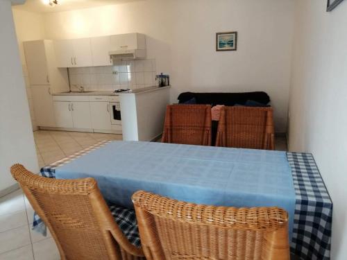 a kitchen with a table and chairs in a room at Relax Apartments Grazia in Funtana