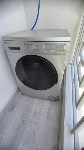 a microwave sitting on the floor next to a window at Cosy Flat with IPTV, BB gear Married couples only in Tangier