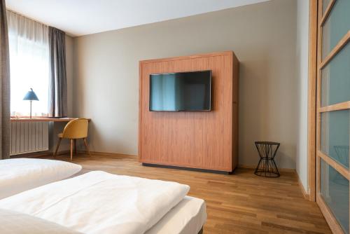 a hotel room with a television on a wall at Residenz Feldmühle unterhalb der Burg Taufers in Campo Tures