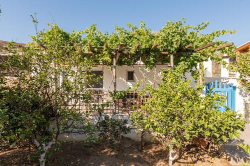 a white house with trees in front of it at Casa Giardino in Livadi Astypalaias