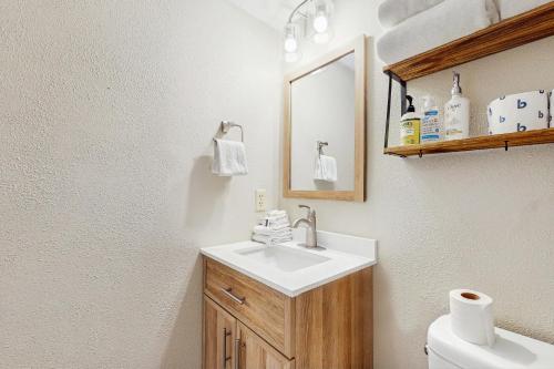 a bathroom with a sink and a mirror and a toilet at Christi Villa 100 in Angel Fire