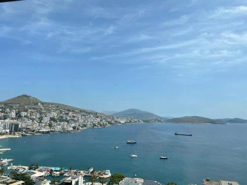 a view of a city with boats in the water at Glory's Apartments Sarande in Sarandë