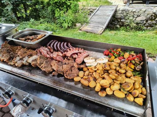 a grill full of different types of meat and vegetables at Salatín in Ružomberok