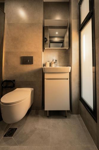 a bathroom with a toilet and a sink at Nemausa Luxury Living in Kallithea Halkidikis