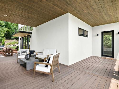 a large deck with chairs and a table at Luxe 5BR with Home Theater, Pool Table and Firepit in Stoney Knob