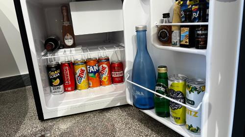an open refrigerator filled with lots of drinks and drinks at La Corte di Partenope Luxury Suite in Naples