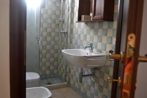 a bathroom with a sink and a toilet at Maison - C'era una Volta in Avetrana