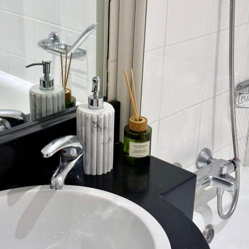a bathroom counter with a sink and a mirror at Heron Gate Comfort, Park and Pillow in Cork