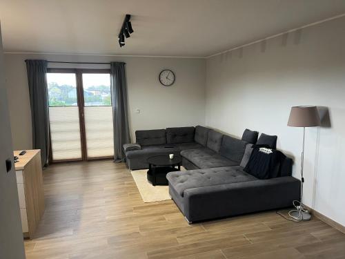 a living room with a couch and a table at Rybnicka 109A in Skorka