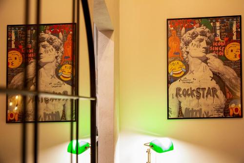 a room with two posters on the wall and a lamp at MANTRA Suite&Rooms in Acerenza