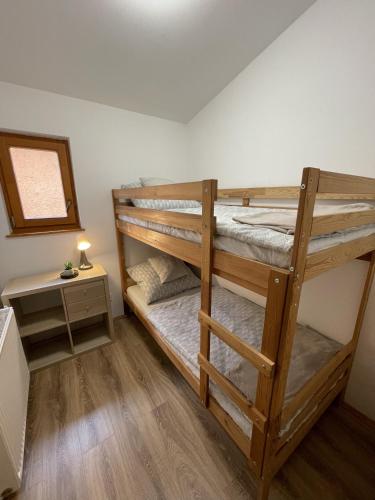 a bunk bed room with two bunk beds at Halász Vendégház Jakuzzival Tiszakécske in Tiszakécske