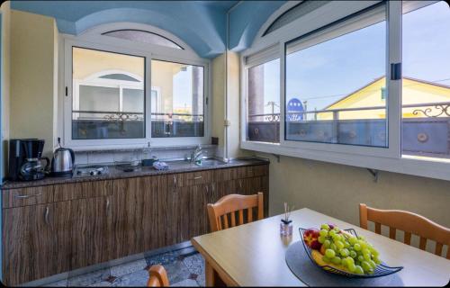 a kitchen with a table with a bowl of fruit on it at Villa Ana Selce in Selce