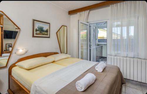 a bedroom with a bed with two white towels on it at Villa Ana Selce in Selce