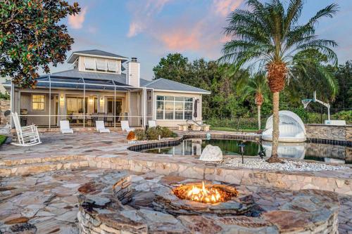 a home with a fire pit in front of a house at 5Br Sleeps 16 Private Pool-Dog Friendly-Fire Pit in Lake Placid