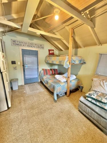 a room with two bunk beds and a couch at PARADISE POINT LIMIT 10 cottage in Casco