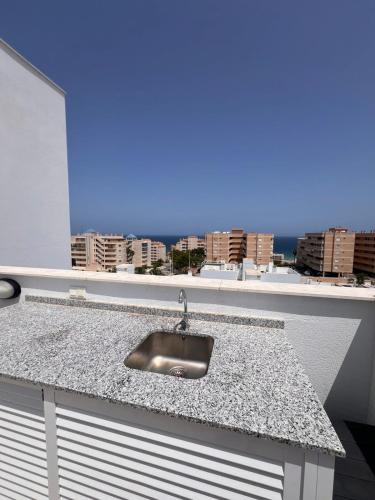 a kitchen counter with a sink and a window at Claudia Luxury in Arenales del Sol