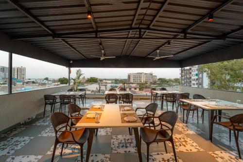 a restaurant with tables and chairs on a roof at Aceotel Select Sarvagya, Vijay Nagar- A Luxury Boutique Hotel -Nipania in Indore