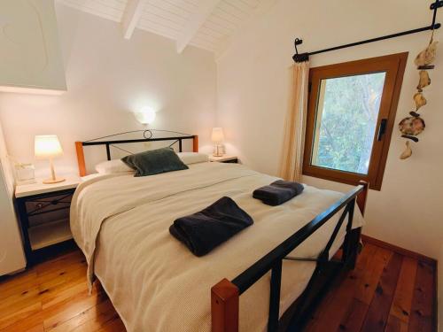 a bedroom with a large bed with two pillows on it at Kalives pearl suite in Kalyves