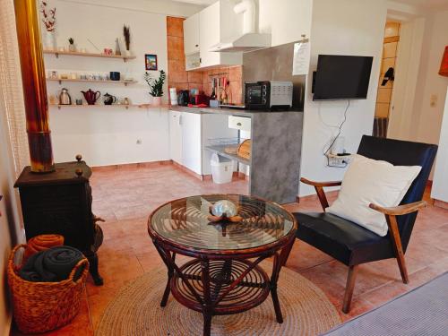 a living room with a coffee table and a kitchen at Kalives pearl suite in Kalyves