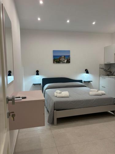 a bedroom with a bed with two towels on it at Javelin's Accomodation in Tropea