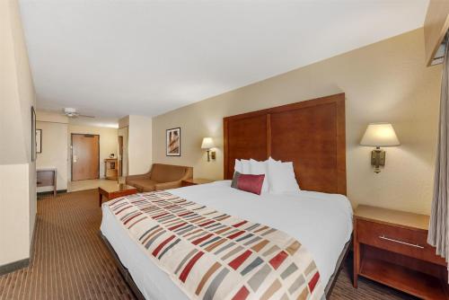 a hotel room with a large bed and a couch at Best Western Alamo Suites in San Antonio