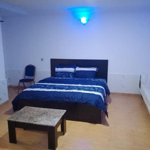 a bedroom with a bed with a blue light on it at Peace Home in Lekki