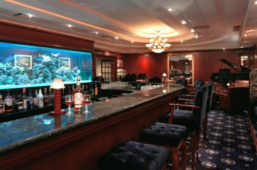 a bar in a hotel with a large aquarium at Chateau Louis Hotel & Conference Centre in Edmonton