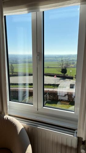 a window in a room with a view of a street at Hotel ons krijtland in Epen