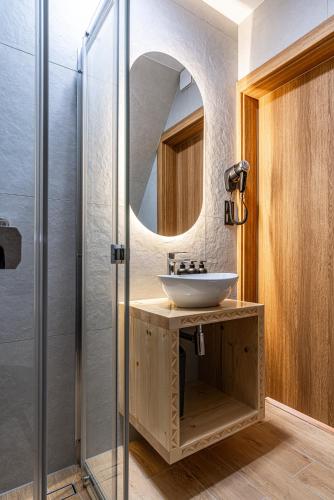 a bathroom with a sink and a mirror at Perła Tatr - Noclegi z widokiem na góry in Zakopane