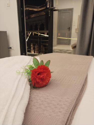a red flower sitting on top of a bed at Garden City Hotel Downtown in Cairo
