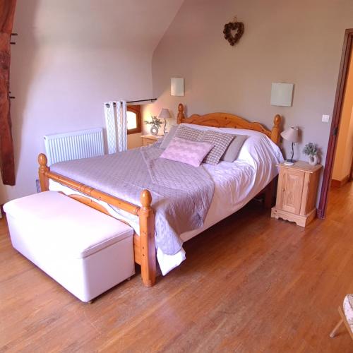 a bedroom with a wooden bed with a wooden floor at CHATEAU DE LACOMTE COUNTRY CLUB in Carlucet