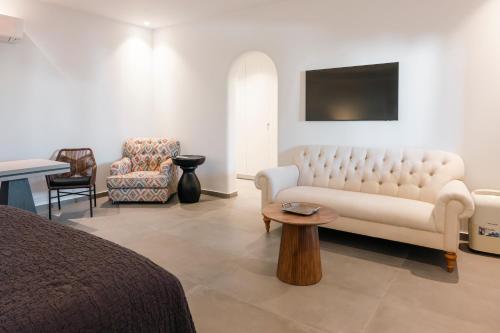 a living room with a couch and a chair at Villa Libertad in Imerovigli