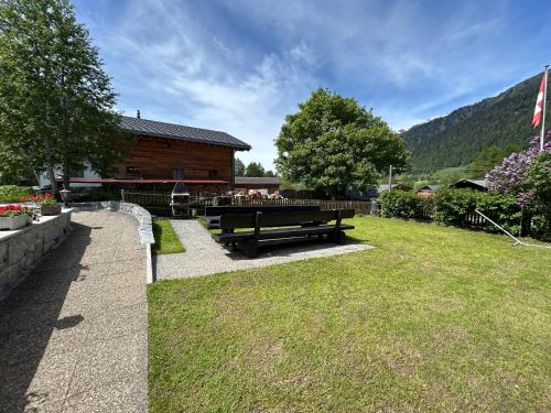 a picnic table in a yard next to a building at Chalet Galmihorn in Reckingen - Gluringen