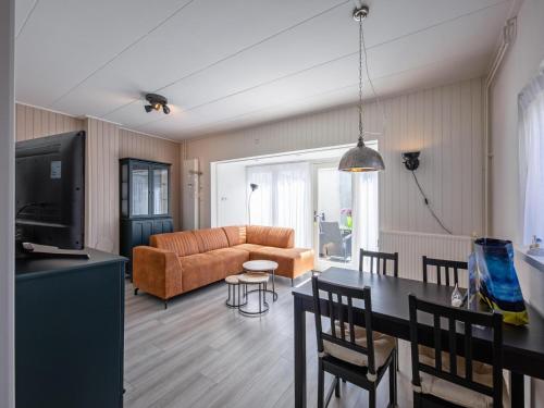 a living room with a couch and a table at Holiday Home in Texel near the Beach in De Koog