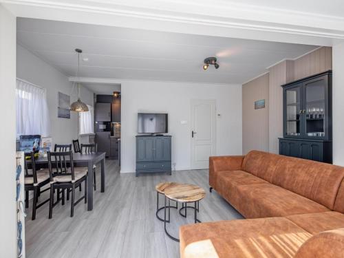 a living room and kitchen with a couch and a table at Holiday Home in Texel near the Beach in De Koog
