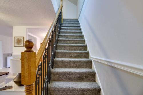 a winding staircase with wooden railings in a house at Pet-Friendly Cottage in DWTN Brainerd in Brainerd