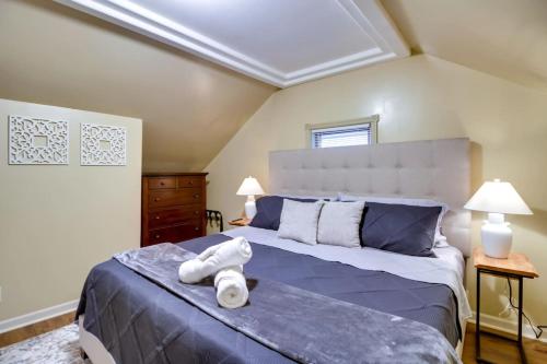 a bedroom with a large bed with towels on it at Pet-Friendly Cottage in DWTN Brainerd in Brainerd